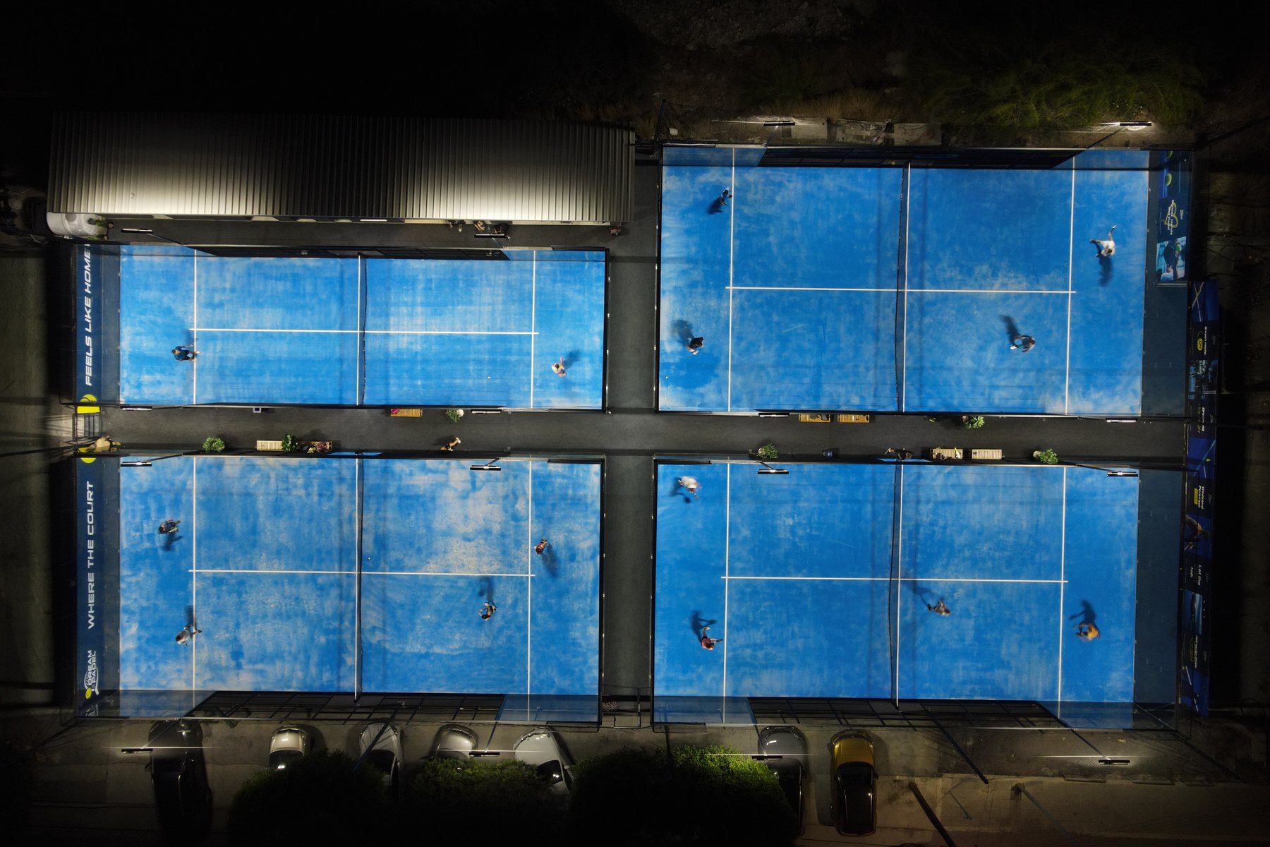 Aerial night view of Dream Padel's four floodlit courts in Limassol